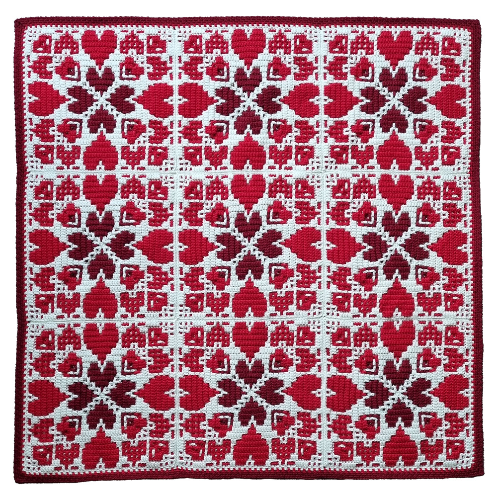 Rosina Plane Everlasting Love Deken - bovenaanzicht van de rood witte gehaakte deken